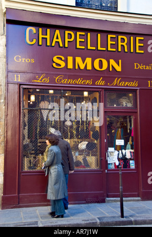 Paris France, Shopping Old Storefront, French Hat shop in the Marais District, People Looking Shop Window (Now Closed) vintage storefront 1950s store, Stock Photo