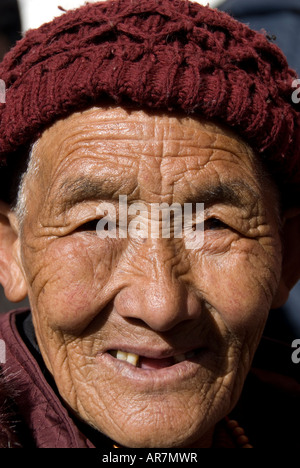 Vertical portrait of an old Tibetan woman on a pilgrimage to the Potala palace, Lhasa,  People’s Republic Of China Stock Photo
