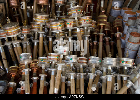 Stacks of Mani prayer wheels for pilgrims in the Barkhor bazaar outside the Jokhang temple in central Lhasa, Tibet Stock Photo