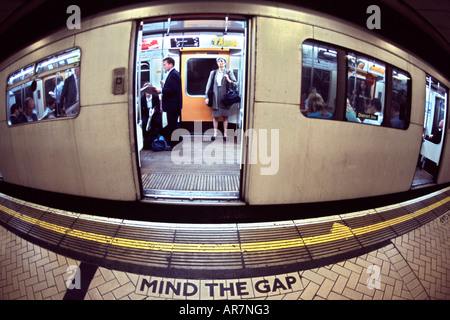 District line underground train at a station platform in London. Photographed with a fish-eye lens, hence the distortion. Stock Photo