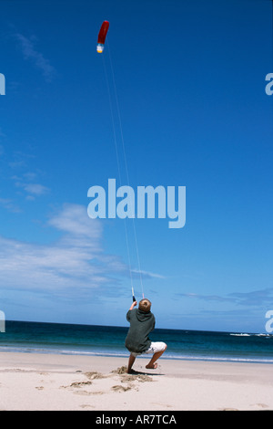 A boy flies a kite on one of Coll's many beaches Stock Photo