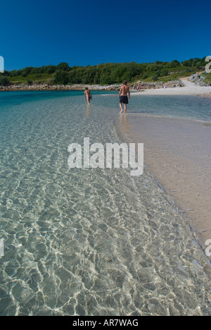 Couple on the sand bar between Gugh and St Agnes islands in the Scilly Isles England UK Stock Photo