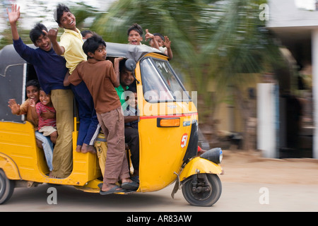 Indian auto rickshaw full of children. Puttaparthi, Andhra Pradesh, India Stock Photo