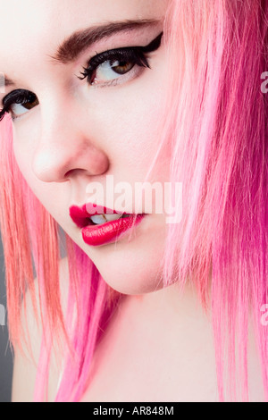 A head shot of a young woman with pink hair. Stock Photo