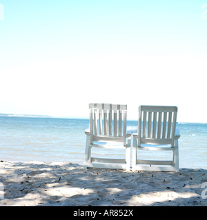 Two deckchairs on sandy beach Stock Photo