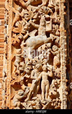 Ornately sculpted pillar with figures from the Dionysian procession at the Basilica of Severus Leptis Magna Libya Stock Photo