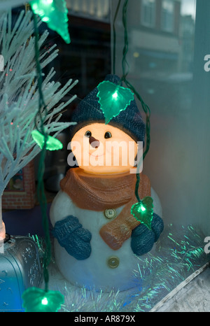 Illuminated snowman in shop window. Stock Photo