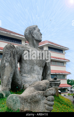 Sculpture of a man sitting up at Technopark. Concept is awakening - sleeping giant waking up to his immense potential Stock Photo