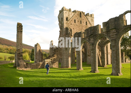 Female tourist in the ruins of Llanthony abbey Llanthony Wales UK Stock Photo