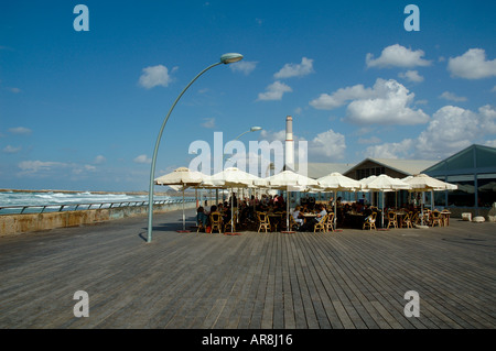 People seated in a restaurant along the promenade at the old Tel Aviv seaport Israel Stock Photo
