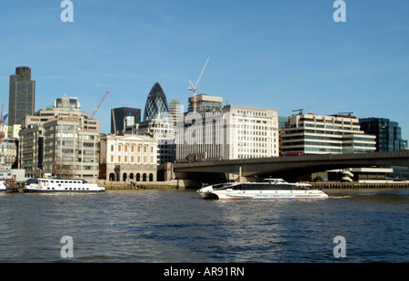 River Thames London England Offices and Tourist Commuter Ferry Tornado Clipper at London Bridge Stock Photo