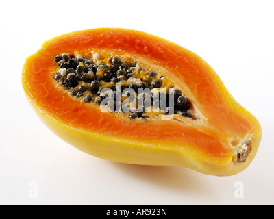 papaya tropical fruit cut in half against a white background as a cut out Stock Photo