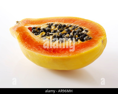 papaya tropical fruit cut in half against a white background as a cut out Stock Photo