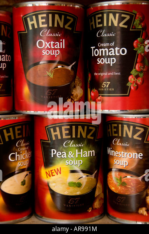 various assorted tin cans of Heinz soups on a kitchen shelf - handy convenience foods  UK Stock Photo