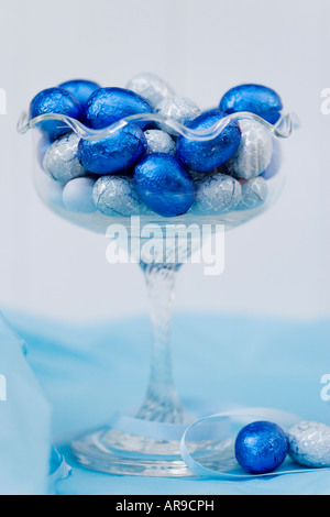 Foil covered chocolate easter eggs in a vintage glass bowl Stock Photo
