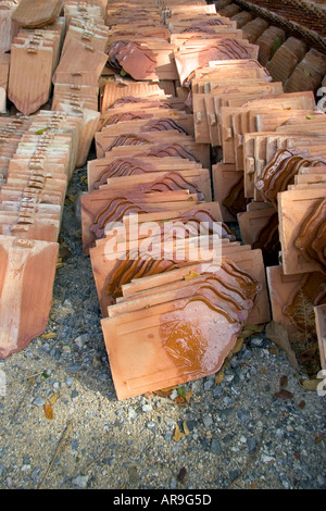 Terracotta roof tiles in rows ready to replace tiles on the Thai Temple at Wat Phra Thong, Phuket, Thailand Stock Photo