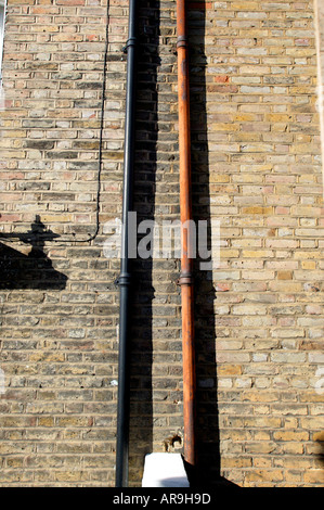 Old and New Down Pipes on a house in london Stock Photo