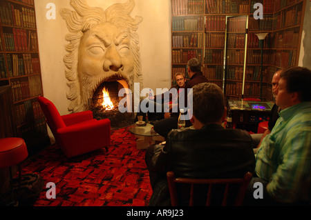 Imposing fireplace and painted bookshelves of the cosy Luna Cafe