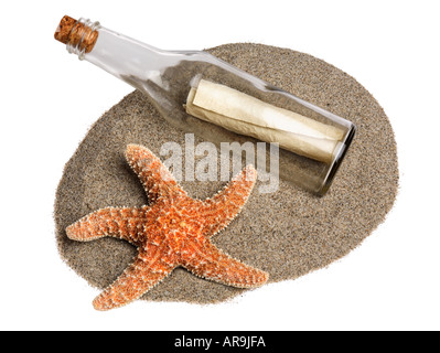 Message in a bottle and starfish on sand Stock Photo