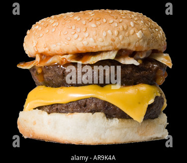 Beef burger in a sesame seed bun with salad dressing and a cheese slice Stock Photo