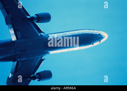 Boeing MD-11 jumbo jet airliner blue sky at cruising altitude aero engines wings Stock Photo