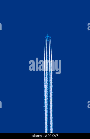 Airbus A340 jumbo jet airliner contrail vapour trail flying at high altitude air lanes airways cruising blue sky Stock Photo