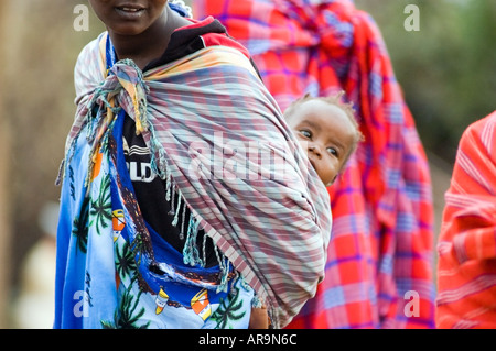 Woman of the Masai tribe with her baby, in their village on the Masai Mara, Kenya, East Africa. Stock Photo