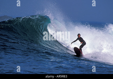 Surfing in Jersey Channel Islands as the sun sets Stock Photo - Alamy