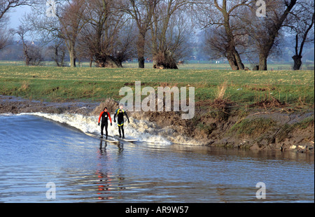 Surfers riding the Seven Bore at Stonebench in gloucestershire England Stock Photo