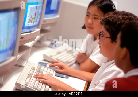 1990’s School Junior Computer Class multiethnic junior school students with keyboards & screen in 90's interactive internet school computer class room Stock Photo