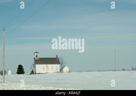 One room schoolhouse on the snow covered prairie Stock Photo