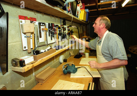 Visually impaired man undertaking DIY at home England Stock Photo