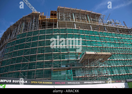 University Campus Suffolk building under construction with scaffolding and safety netting, Ipswich Wet Dock, Suffolk, England Stock Photo