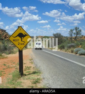 van passing Kangaroo warning sign in the Outback near Alice Springs in Northern Territory of Australia Stock Photo