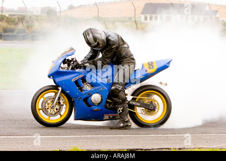 A competitor at the Belfast & District Centenary races at Kirkistown Co Down in September 2006 does a post race burnout Stock Photo