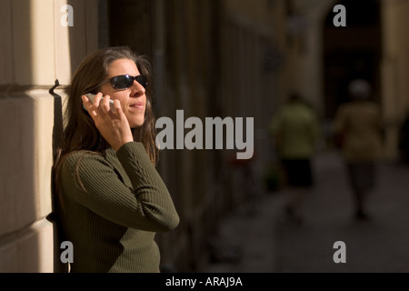 Young woman using a mobile in the streets of Vicenza Italy Stock Photo