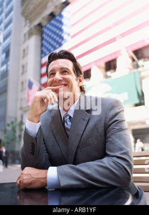 Man with Laptop Computer by American Flag Stock Photo