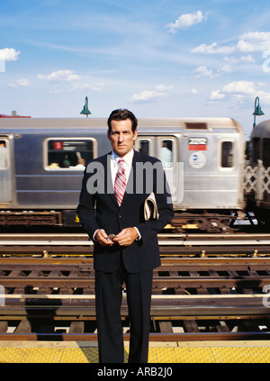 Businessman Waiting For Train Stock Photo