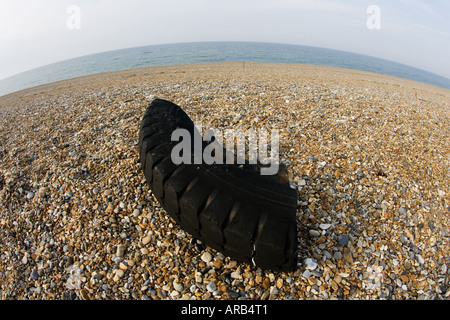 Remains of tyre washed up on Cley beach North Norfolk United Kingdom Stock Photo