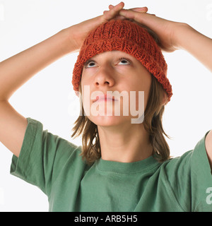 Teenaged Boy With Hands on Head