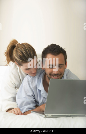 Couple in Bed, Using Laptop Stock Photo