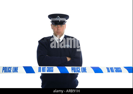 British Police officer standing on a cordon wearing flat cap with his arms folded Isolated on a pure white background Stock Photo