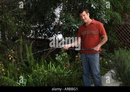 Man Watering Garden Stock Photo