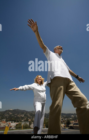 Mature Couple Pretending to Fly Stock Photo