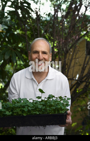 Man Holding Tray of Plants Stock Photo