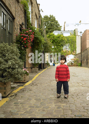 Portrait of Boy Standing In Street, Portobello, London, England Stock Photo