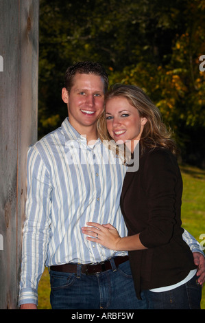 A young man and a young woman smiling and cuddling Stock Photo
