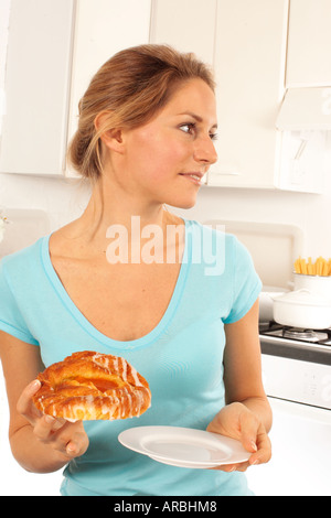 GIRL EATING DANISH PASTRY Stock Photo