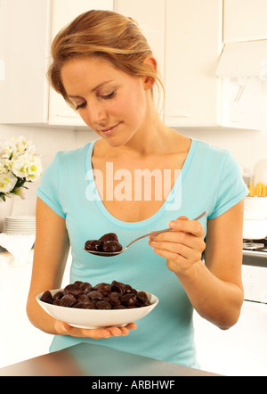 WOMAN EATING PRUNES Stock Photo