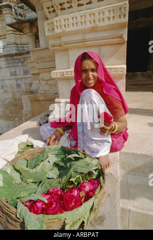 Woman selling flowers outside the Jain Temple of Chaumukha, Rajasthan, India Stock Photo